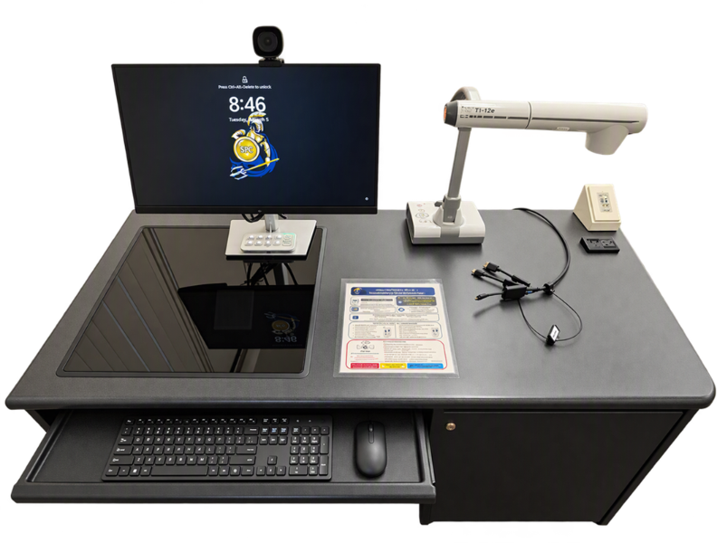 Top-down photo of a classroom instructor station with monitor, webcam, document camera, room controller, HDMI cables and keyboard tray